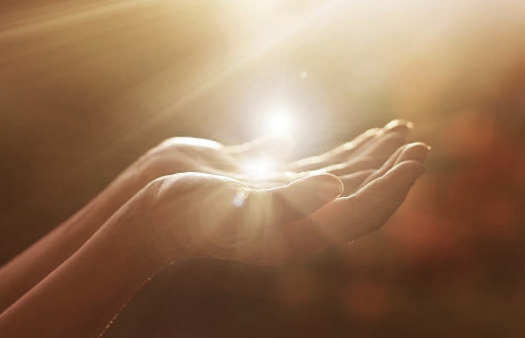 Cupped hands holding light