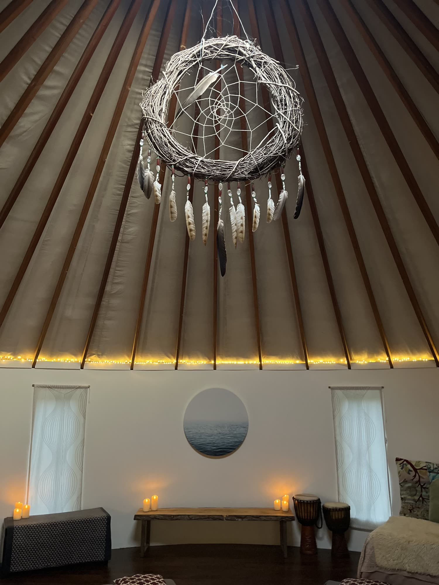 The yurt crown — dreamcatcher hanging beneath the skylight.