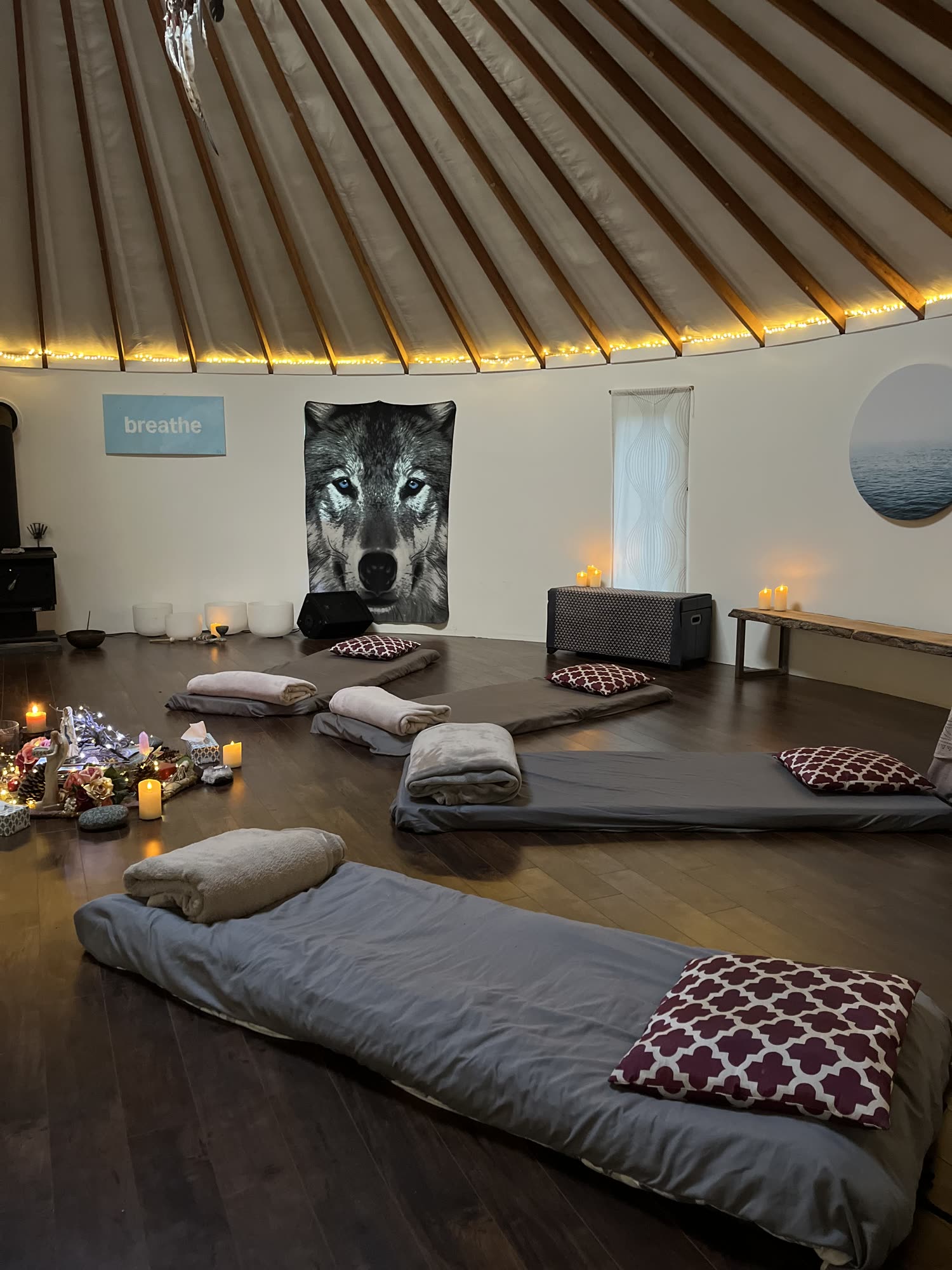 Yurt interior — wood floor with bolsters and altar.